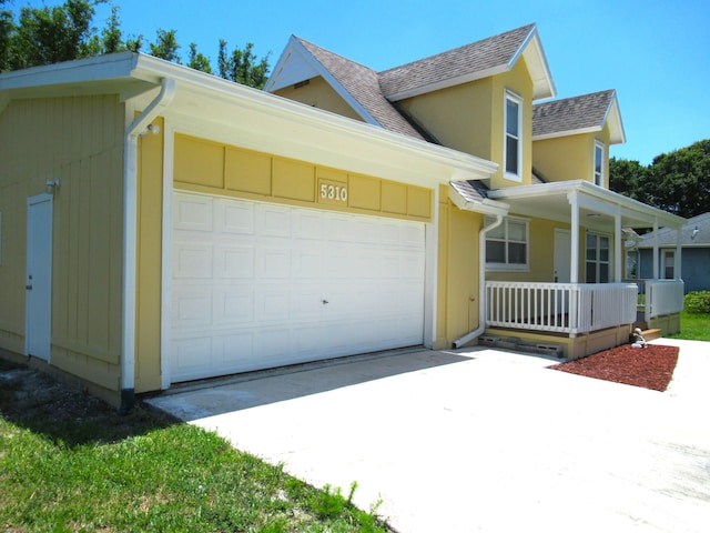 5310 Palm Dr, Fort Pierce, FL 34982 - view of front of house with a shingled roof, a porch, a garage, and concrete driveway