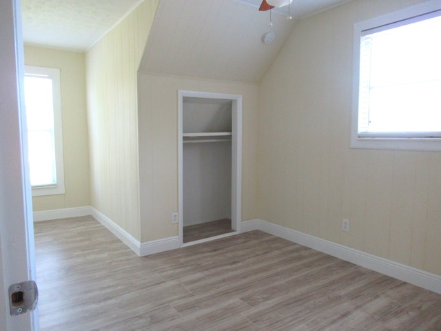 5310 Palm Dr, Fort Pierce, FL 34982 - unfurnished bedroom with light wood-style flooring, lofted ceiling, a closet, baseboards, and ceiling fan