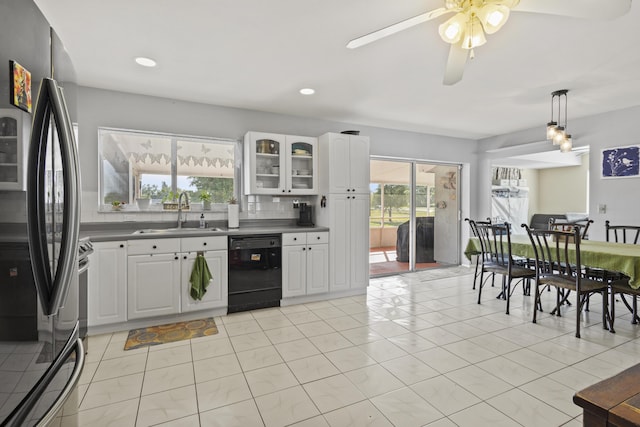 2008 SE Triumph Rd, Port Saint Lucie, FL 34952 - kitchen with black dishwasher, a sink, freestanding refrigerator, glass insert cabinets, and white cabinetry