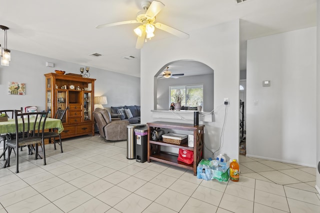 2008 SE Triumph Rd, Port Saint Lucie, FL 34952 - living room with a ceiling fan, light tile patterned floors, and arched walkways