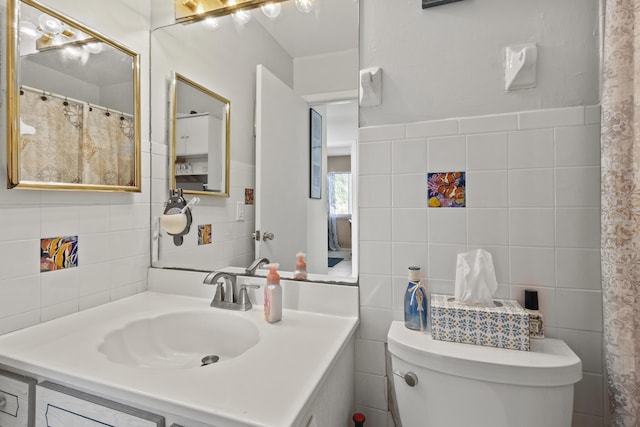 2008 SE Triumph Rd, Port Saint Lucie, FL 34952 - full bathroom featuring tile walls, toilet, and vanity
