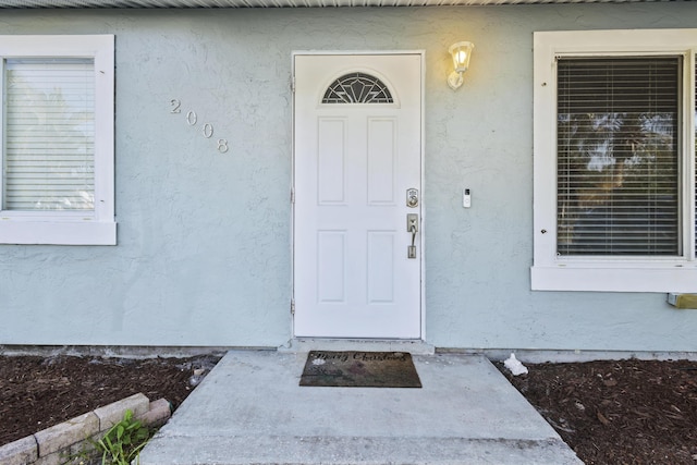 2008 SE Triumph Rd, Port Saint Lucie, FL 34952 - doorway to property with stucco siding