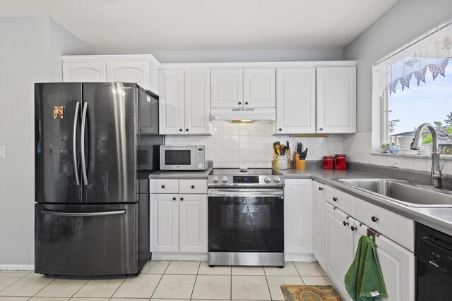 2008 SE Triumph Rd, Port Saint Lucie, FL 34952 - kitchen featuring freestanding refrigerator, stainless steel electric range oven, under cabinet range hood, a sink, and white microwave