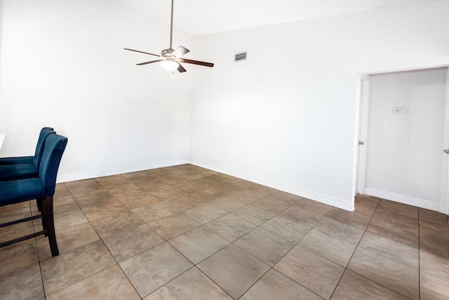 unfurnished office featuring ceiling fan, baseboards, and lofted ceiling