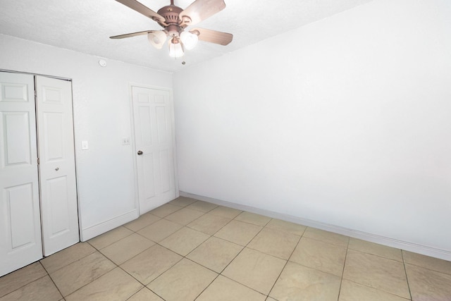 unfurnished bedroom with a closet, a ceiling fan, and baseboards