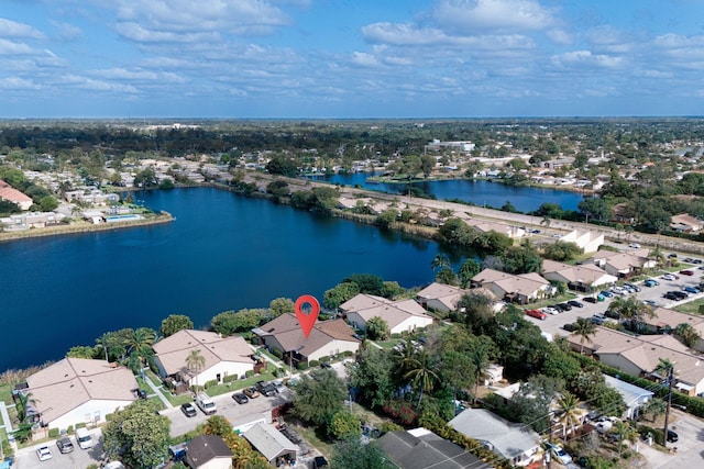 view of property location featuring a nearby body of water and nearby suburban area