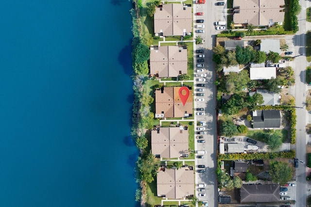 view of property location with a large body of water, nearby suburban area, and property parcel outlined