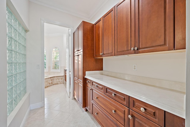 9606 Shepard Pl, Wellington, FL 33414 - kitchen featuring crown molding, light tile patterned flooring, brown cabinets, and light countertops