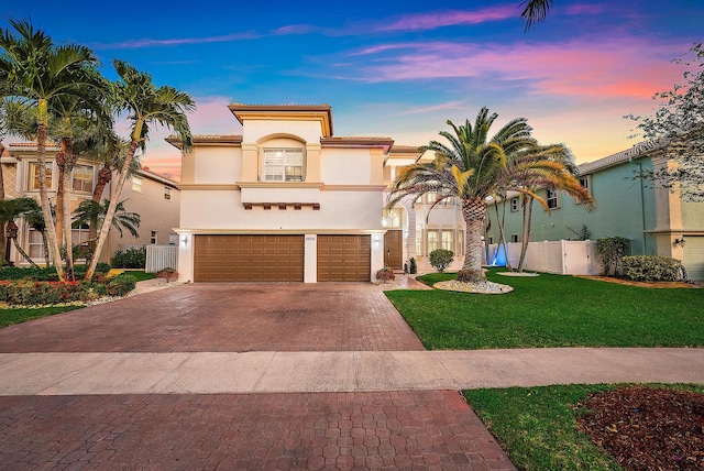 9606 Shepard Pl, Wellington, FL 33414 - mediterranean / spanish home with decorative driveway, stucco siding, an attached garage, and a tiled roof