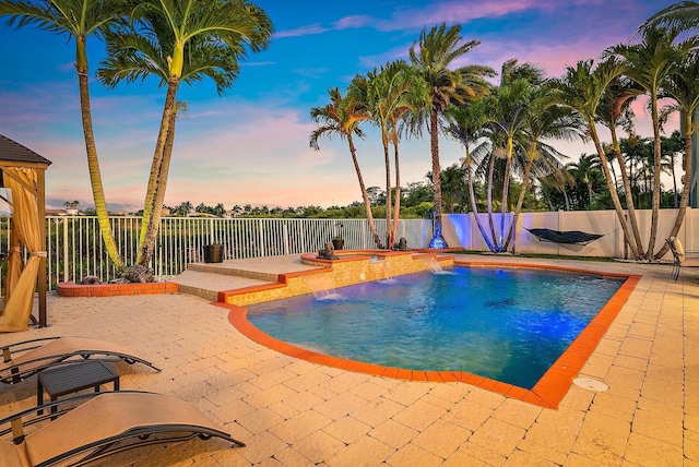 9606 Shepard Pl, Wellington, FL 33414 - pool at dusk featuring a patio area and a fenced backyard