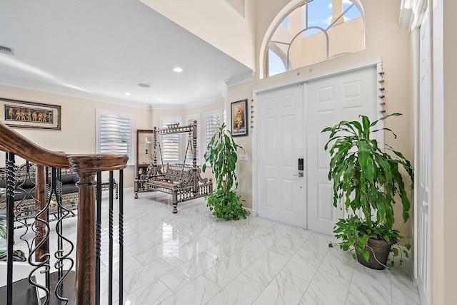 9606 Shepard Pl, Wellington, FL 33414 - foyer featuring plenty of natural light, recessed lighting, light marble finish flooring, ornamental molding, and baseboards