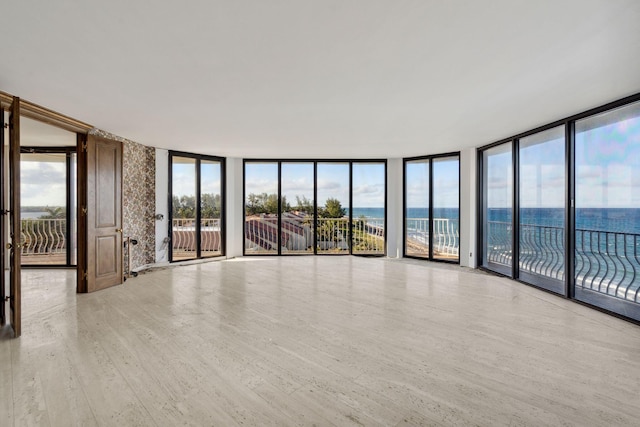 2000 S Ocean Blvd Unit 501N, Palm Beach, FL 33480 - empty room with expansive windows, a water view, and wood finished floors