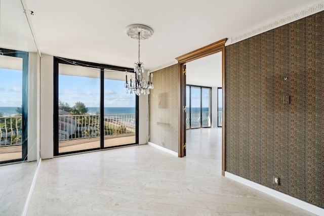 2000 S Ocean Blvd Unit 501N, Palm Beach, FL 33480 - spare room with a chandelier, a water view, wallpapered walls, floor to ceiling windows, and baseboards