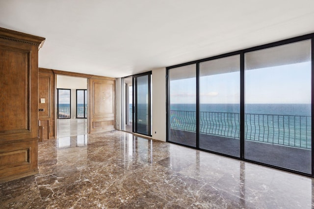 2000 S Ocean Blvd Unit 501N, Palm Beach, FL 33480 - unfurnished room with a wall of windows, marble tiled floors, healthy amount of natural light, and a water view