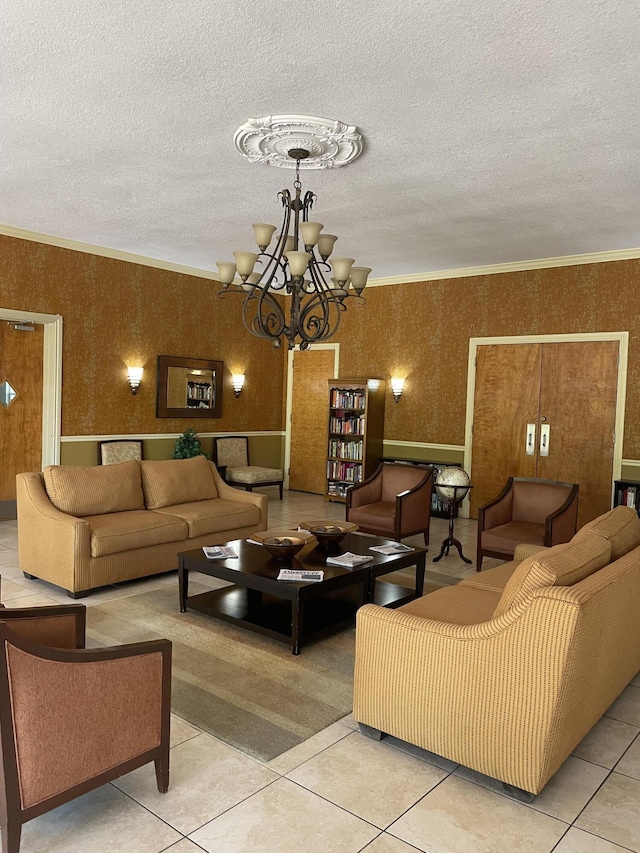 tiled living room with a textured ceiling, a chandelier, wallpapered walls, and ornamental molding