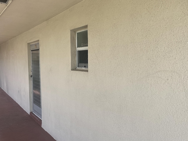 view of side of home with stucco siding