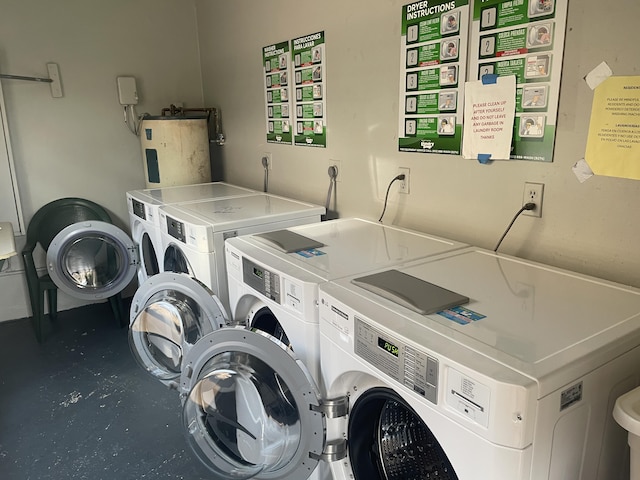 shared laundry room featuring independent washer and dryer and water heater