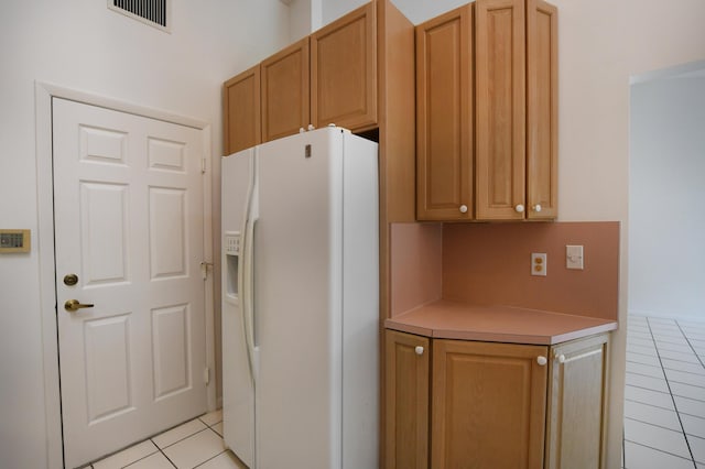 17215 Boca Club Blvd Unit 2, Boca Raton, FL 33487 - kitchen with white refrigerator with ice dispenser, light tile patterned floors, and light countertops