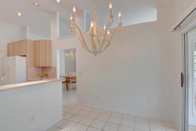 17215 Boca Club Blvd Unit 2, Boca Raton, FL 33487 - kitchen featuring white refrigerator with ice dispenser, a chandelier, light brown cabinets, a towering ceiling, and light countertops