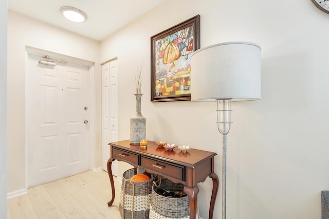 foyer entrance featuring light wood-style floors and baseboards