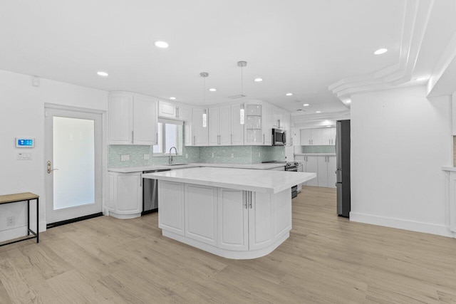 2611 NE 49th St, Lighthouse Point, FL 33064 - kitchen with a sink, stainless steel appliances, light countertops, white cabinets, and recessed lighting
