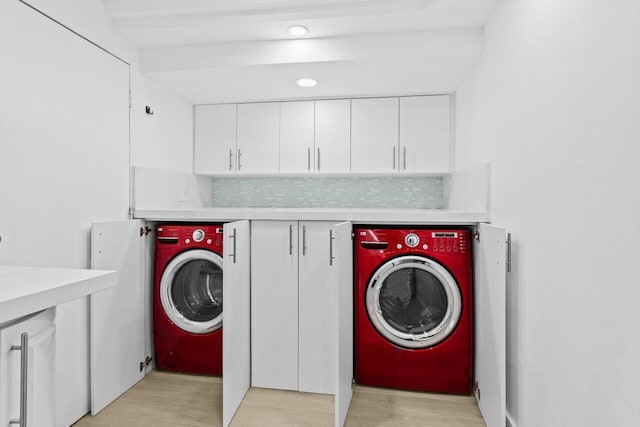 2611 NE 49th St, Lighthouse Point, FL 33064 - laundry room featuring washer / dryer and light wood-style floors