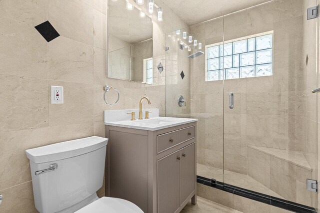 2611 NE 49th St, Lighthouse Point, FL 33064 - full bathroom with toilet, a stall shower, vanity, and tile walls