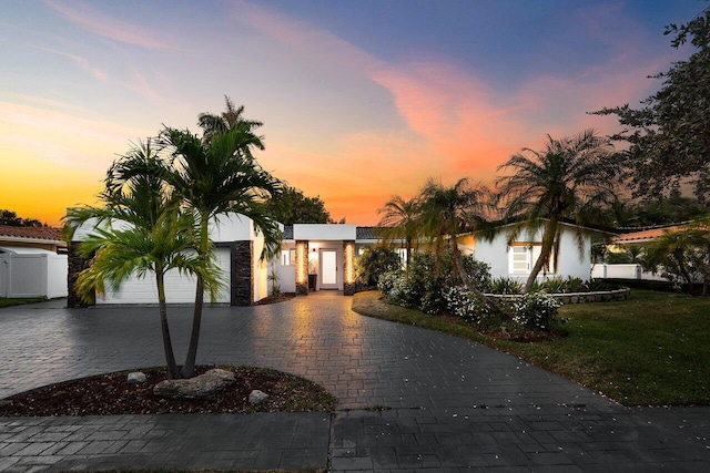 2611 NE 49th St, Lighthouse Point, FL 33064 - view of front of home with decorative driveway, stucco siding, and a garage