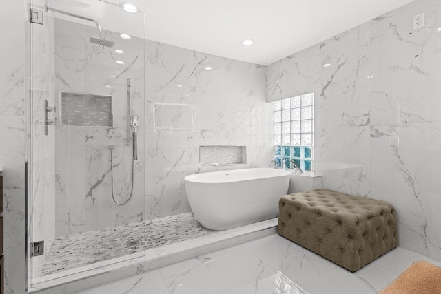 2611 NE 49th St, Lighthouse Point, FL 33064 - full bath with marble tiled floors, a marble finish shower, a freestanding bath, stone wall, and recessed lighting