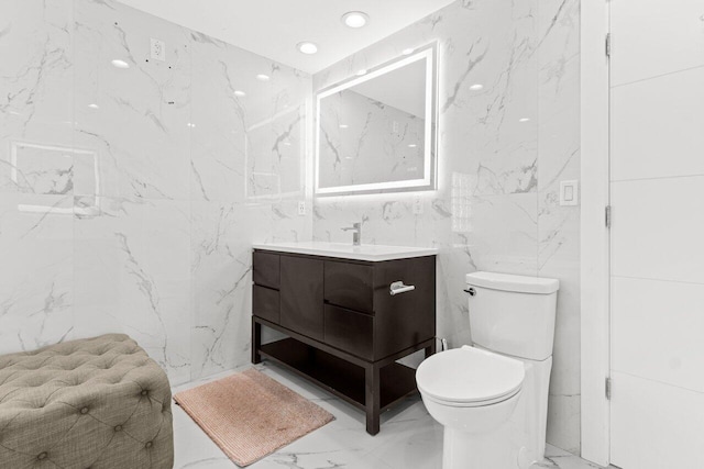 2611 NE 49th St, Lighthouse Point, FL 33064 - bathroom featuring vanity, marble tiled floors, tile walls, toilet, and recessed lighting