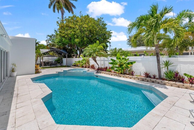 2611 NE 49th St, Lighthouse Point, FL 33064 - view of pool featuring a patio area, a fenced backyard, a gazebo, and a pool with connected hot tub