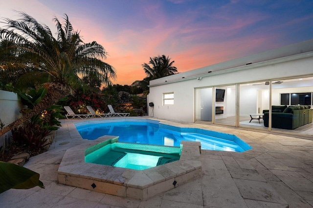 2611 NE 49th St, Lighthouse Point, FL 33064 - view of swimming pool featuring a patio area, a pool with connected hot tub, and an outdoor living space