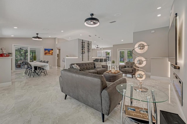 11849 59th St N, Royal Palm Beach, FL 33411 - living room featuring lofted ceiling, light marble finish floors, baseboards, and recessed lighting