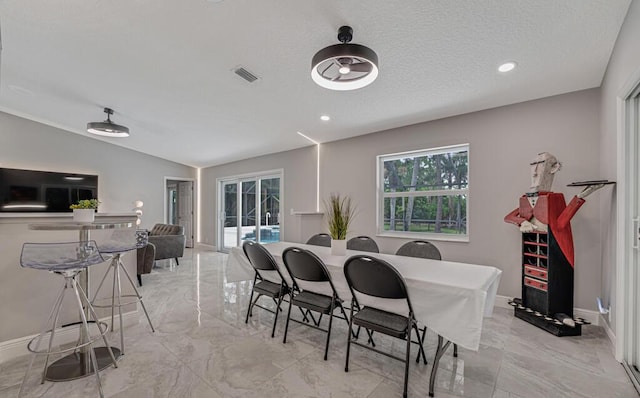 11849 59th St N, Royal Palm Beach, FL 33411 - dining space featuring light marble finish floors, baseboards, recessed lighting, and lofted ceiling