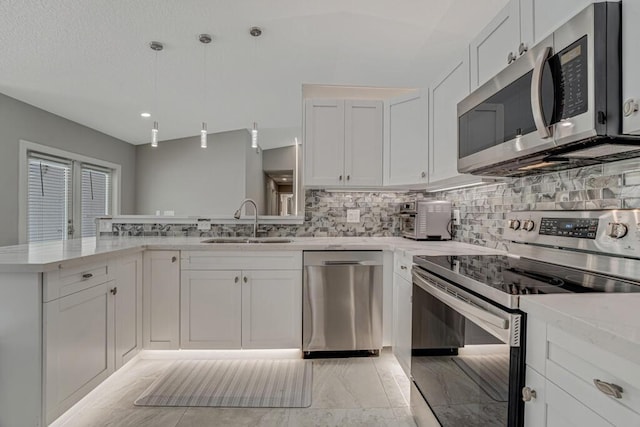 11849 59th St N, Royal Palm Beach, FL 33411 - kitchen with stainless steel appliances, a sink, tasteful backsplash, light stone counters, and white cabinets