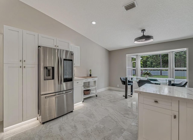 11849 59th St N, Royal Palm Beach, FL 33411 - kitchen featuring stainless steel refrigerator with ice dispenser, lofted ceiling, baseboards, light marble finish flooring, and a textured ceiling