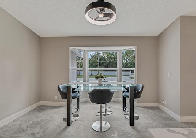11849 59th St N, Royal Palm Beach, FL 33411 - dining space with light marble finish flooring, a textured ceiling, baseboards, and a desk