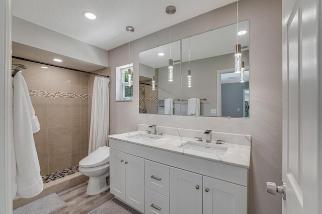 11849 59th St N, Royal Palm Beach, FL 33411 - bathroom featuring a stall shower, double vanity, toilet, wood finished floors, and recessed lighting