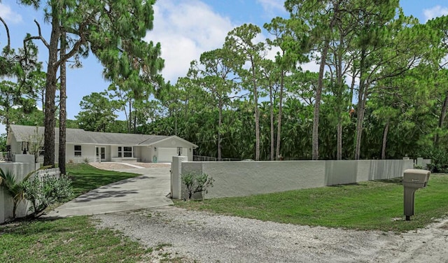 11849 59th St N, Royal Palm Beach, FL 33411 - view of front of home featuring gravel driveway and an attached garage