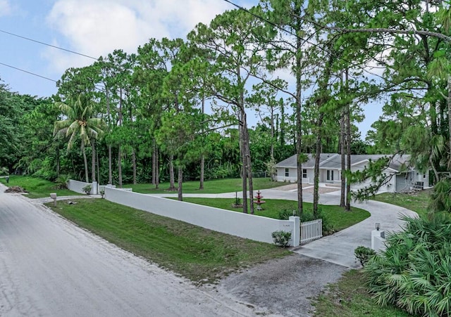 11849 59th St N, Royal Palm Beach, FL 33411 - view of property's community featuring driveway, a gate, and view of wooded area