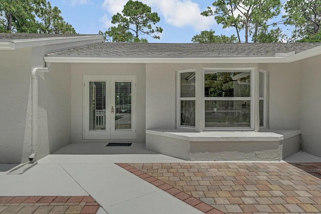 11849 59th St N, Royal Palm Beach, FL 33411 - doorway to property with french doors, stucco siding, roof with shingles, and a patio area