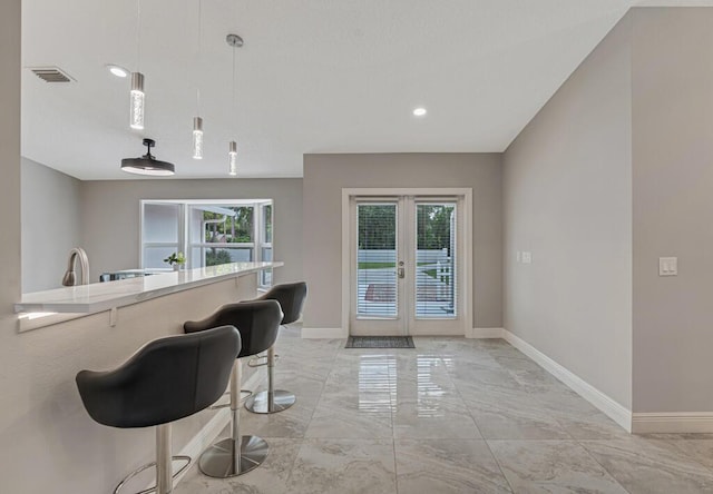 11849 59th St N, Royal Palm Beach, FL 33411 - kitchen featuring french doors, plenty of natural light, baseboards, light marble finish floors, and recessed lighting