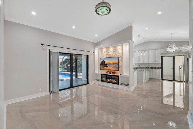 3 Independence Ct, Deerfield Beach, FL 33442 - unfurnished living room with ornamental molding, a chandelier, a glass covered fireplace, vaulted ceiling, and baseboards