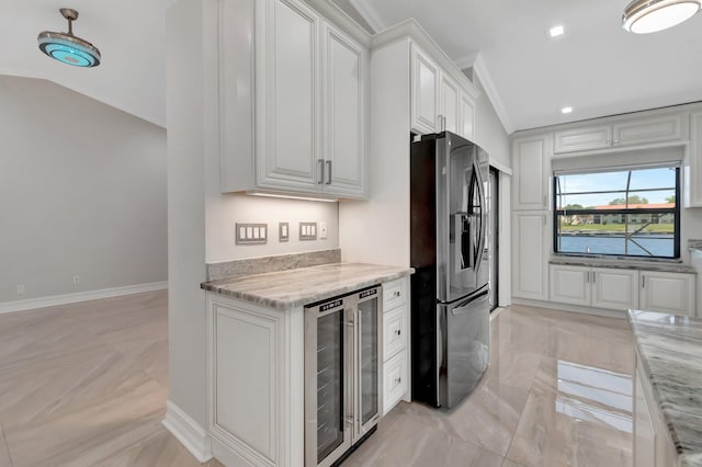 3 Independence Ct, Deerfield Beach, FL 33442 - kitchen with wine cooler, stainless steel fridge with ice dispenser, white cabinets, light stone counters, and ornamental molding