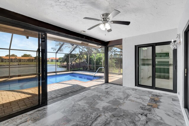 3 Independence Ct, Deerfield Beach, FL 33442 - swimming pool featuring a patio, ceiling fan, glass enclosure, and a water view