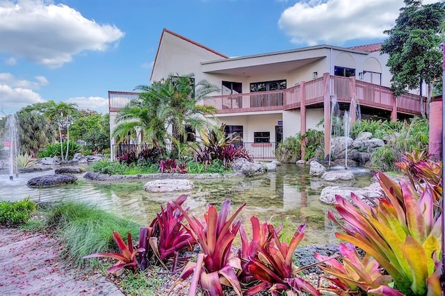 3 Independence Ct, Deerfield Beach, FL 33442 - back of house with stucco siding and a balcony