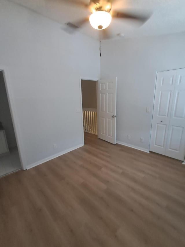 4964 Palmbrooke Cir, West Palm Beach, FL 33417 - unfurnished bedroom featuring wood finished floors, baseboards, and a ceiling fan
