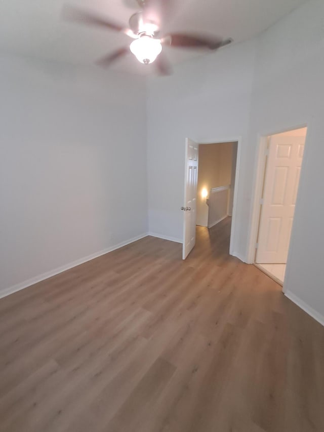 4964 Palmbrooke Cir, West Palm Beach, FL 33417 - unfurnished bedroom featuring light wood-style flooring, baseboards, and ceiling fan