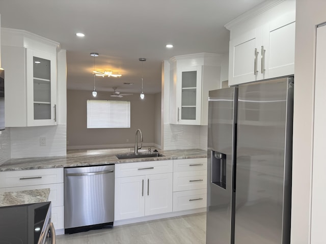 14814 Wildflower Ln, Delray Beach, FL 33446 - kitchen with appliances with stainless steel finishes, a sink, white cabinets, glass insert cabinets, and recessed lighting