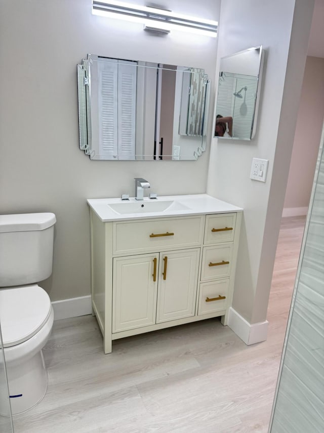 14814 Wildflower Ln, Delray Beach, FL 33446 - bathroom with baseboards, toilet, and wood finished floors